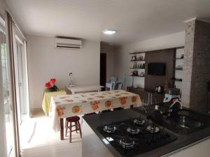 a kitchen with a table with a table cloth on it at Casa da Piscina in Rolante