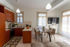 a kitchen with a table and a dining room at GG Αpartment in Leonidio