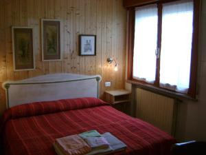 a bedroom with a bed with two towels on it at B&B Lattemiele in Fontanellato