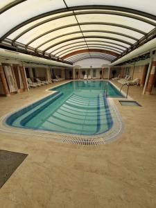 a large swimming pool in a large building at Apartment Sunrise in Zalakaros