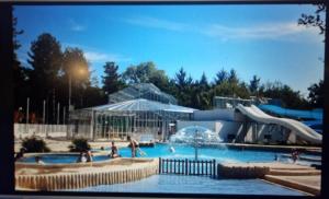 a pool with a water park with people playing in it at Camping de Bayadene in Piriac-sur-Mer