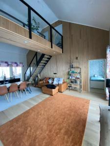 sala de estar con escalera, sofá y mesa en Villa Ensola with pool, en Savonlinna