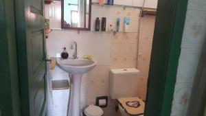 a small bathroom with a sink and a toilet at Casa na cidade ITAPARICA Bahia House in ITAPARICA town in Itaparica +21 photos
