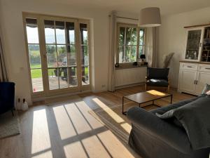 a living room with a couch and a table at Haus Seeglück am Prüßsee in Güster