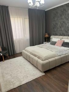 a bedroom with a large white bed with a white rug at Guest House Amaya in Plovdiv