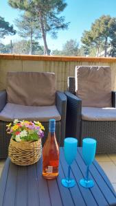 a table with two glasses and a bottle of wine at La Dolce Vita - Apartment with shared pool and large terrace in Lido delle Nazioni