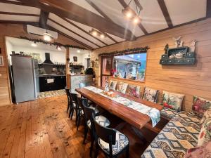 a dining room with a wooden table and chairs at Villa Boro in Beli Iskar