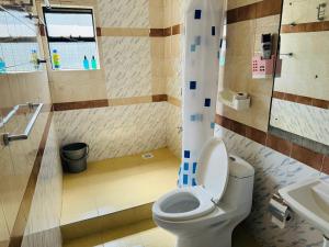 a bathroom with a toilet and a sink at Kiana homes lantana in Nairobi