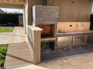 a outdoor kitchen with a counter and a sink at Location Spay Proche circuit in Spay