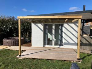 a wooden pergola on a deck in a yard at Location Spay Proche circuit in Spay +2 photos