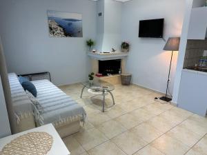 a living room with a couch and a table at MileniKo Beach Villa in Sozopoli