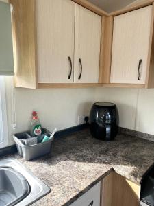 a kitchen counter with a sink and a microwave at MoonStone in Aberystwyth