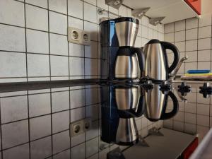a group of utensils on a counter in a kitchen at Ferienhaus Gerd Janssen - Wohnung Nr 2 in Spiekeroog +10 photos