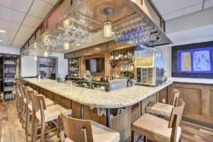 een grote keuken met een lange bar met stoelen bij MiraLago Island Retreat in Lago Vista