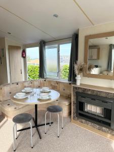 a dining room with a table and chairs and a fireplace at MoonStone in Aberystwyth +31 photos