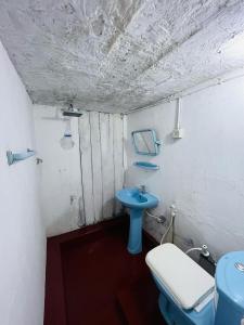 a bathroom with a blue sink and a toilet at A9 home residence in Tangalle +11 photos
