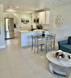 a kitchen and living room with a table and chairs at Close to everything! Perfect basecamp for WPB in West Palm Beach