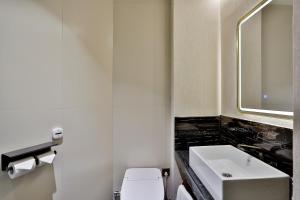 a bathroom with a sink and a toilet at Yurong West Lake Cottage Resort Hotel Hangzhou in Hangzhou