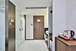 a hallway with a door leading to a room at Yurong West Lake Cottage Resort Hotel Hangzhou in Hangzhou