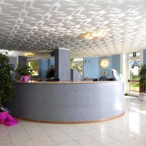 a lobby with a reception counter in a building at Hotel Centro Turistico Gardesano in Bussolengo