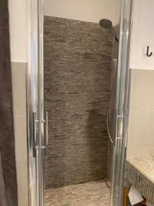a shower with a glass door in a bathroom at La perla del Colosseo in Rome
