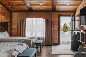 a bedroom with two beds and a sliding glass door at The View Boutique Hotel Suites in Tully