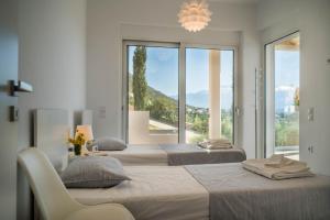 Ένα ή περισσότερα κρεβάτια σε δωμάτιο στο Villa Penelope, a breathtaking view