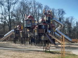 a playground with a slide in a park at Na Starówce in Lidzbark