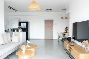 een woonkamer met een bank en een tafel bij O&O Group Luxury Tower 4BR Panoramic Sea Views in Bat Yam