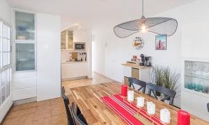 a dining room and kitchen with a table and chairs at Calle Goya 108 in Arguineguín +11 photos