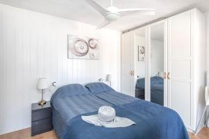 a bedroom with a blue bed with a hat on it at Calle Goya 108 in Arguineguín