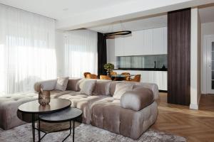 a living room with a couch and a table at SkyView Apartment Unic, Select, Ultimul Etaj, Confort Premium în Royal Town Copou in Iaşi