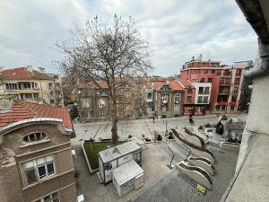 a view of a courtyard in a city with buildings at Two-Bedroom Apartment in the Heart of Burgas, Bogoridi Street in Burgas City