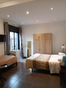 A bed or beds in a room at B&B Villa Lidia
