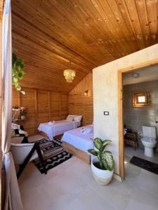 a large room with two beds and a bathroom at Meddur Siwa Oasis in Siwa
