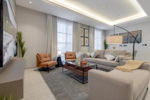 a living room with a couch and a table at أكاريم أفينيوز Akareem Avenues in Riyadh