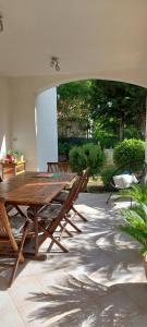 a patio with a wooden table and benches at Ana in Premantura +6 photos