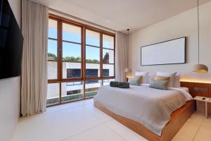 a bedroom with a large bed and a large window at 2 Bedroom Entire Place Villa Harmony Uluwatu Bingin in Uluwatu +36 photos
