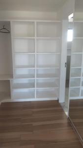 a room with white shelves and a mirror at Casa de Férias - Refúgio Arembepe in Camaçari