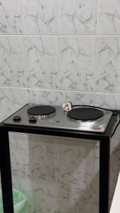 a black stove with two burners on a counter at شقق الشويش المخدومة - فئة اقتصادي in Taif +44 photos