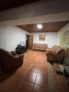 a living room with two couches and a television at House Mariona in Caminha