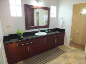 a bathroom with a sink and a mirror at Vacation Garden Villa in Thalang +49 photos
