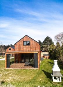 a barn house with a large deck and a bench at TOP house with private HOT TUB-near sea, lakes and forest in Kołczewo