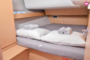 two beds in the middle of a small room at Rent a Cabin on a Sailing Yacht! in Pula