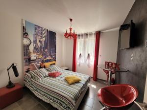 a bedroom with a bed and a red chair at Haute-loire Tence Belle maison neuve plain-pied 4 étoiles avec parc arboré clos in Tence +24 photos