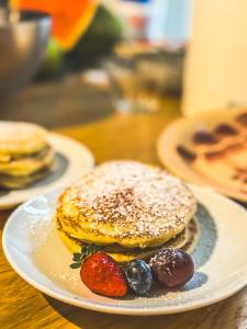 a plate with pancakes and strawberries on a table at Villa Emma Malcesine in Malcesine