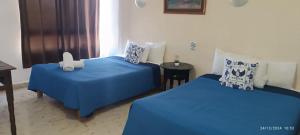 Cama ou camas em um quarto em Hotel Coral