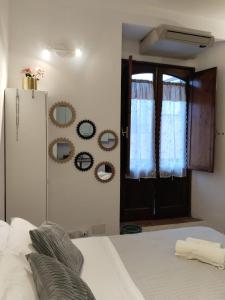 1 dormitorio con cama, ventana y espejos en Taorminacentre IN TOWN, en Taormina