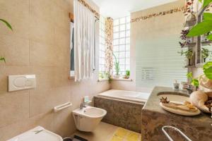 a bathroom with a tub and a toilet and a sink at Beco do Patalugo in Salir de Matos +50 photos
