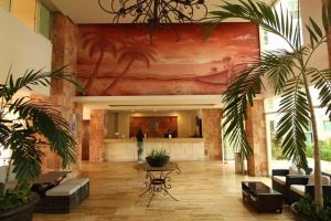 a lobby with palm trees and a table in a building at Habitación en Condominio frente al mar Nuevo Vallarta in Nuevo Vallarta  +88 photos